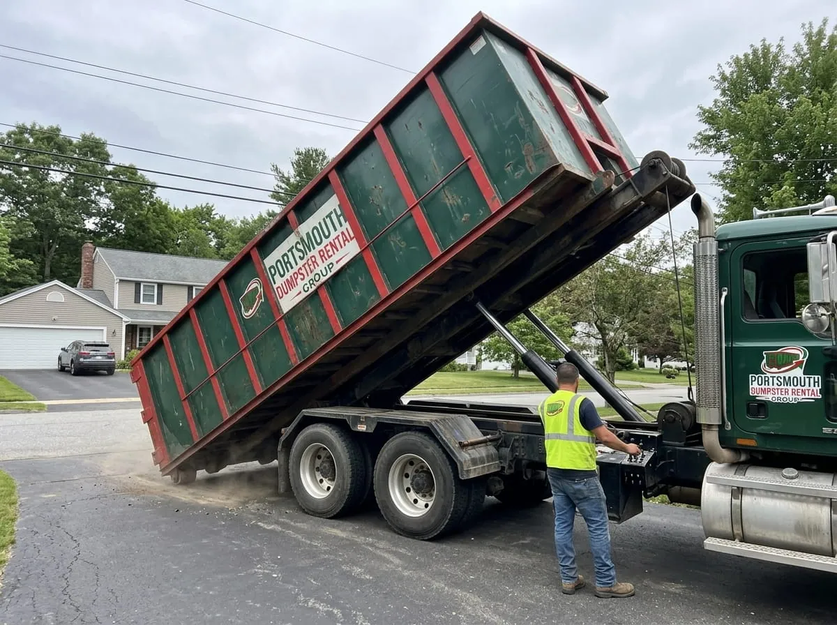 Troy Ballard and the Portsmouth Dumpster Rental Group team beside a company truck and dumpster in Portsmouth, VA